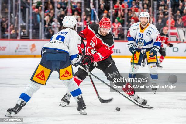 Jiri Sekac of Lausanne HC battles for the puck with Dominik Schlumpf of EV Zug during the National League match between Lausanne HC and EV Zug at...