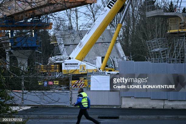 Gandarme walks past a construction site, where the deck of a bridge on the third line of the Toulouse metro collapsed, in Labege, near Toulouse,...
