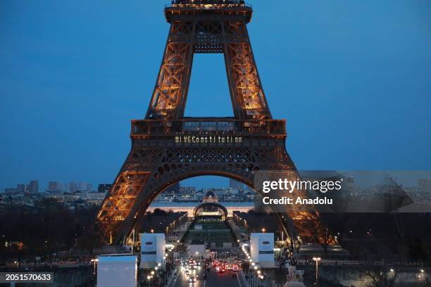 Reading 'I VG Constitution' is projected onto the Eiffel Tower as demonstrators demanding the inclusion of the right to abortion in the constitution...