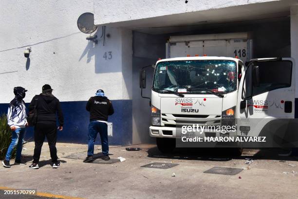 Students of the Raul Isidro Burgos Rural Normal School of Ayotzinapa throw firecrackers at the Attorney General's Detention Center in Mexico City on...