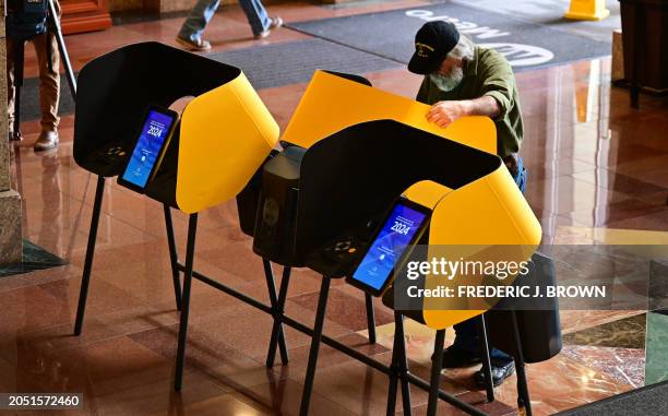 Man casts his ballot during early voting at a polling location at Union Station in Los Angeles, California, on March 4, 2024 ahead of the California...