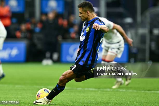 Inter Milan's Chilean forward Alexis Sanchez shoots to score his team's second goal on a penalty kick during the Italian Serie A football match...