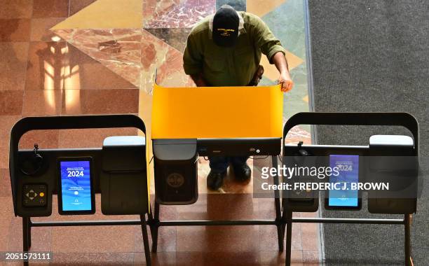 Man casts his ballot during early voting at a polling location at Union Station in Los Angeles, California, on March 4, 2024 ahead of the California...