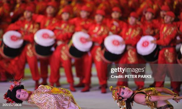 Dancers peform during the opening ceremony of the 16th Asian Games in Guangzhou on November 12, 2010. Athletes from 45 countries and territories will...