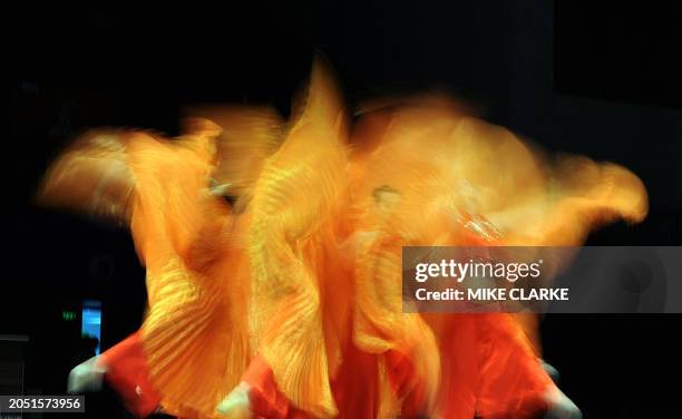 Dancers perform during the break in the fencing competiton at the 16th Asian Games in the southern Chinese city of Guangzhou on November 19, 2010....