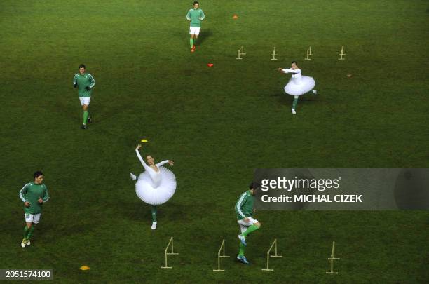 Ballet dancer and members of the Bohemians 1905 junior football team perform on the field on October 22, 2011 at the Czech famous Bohemians 1905...