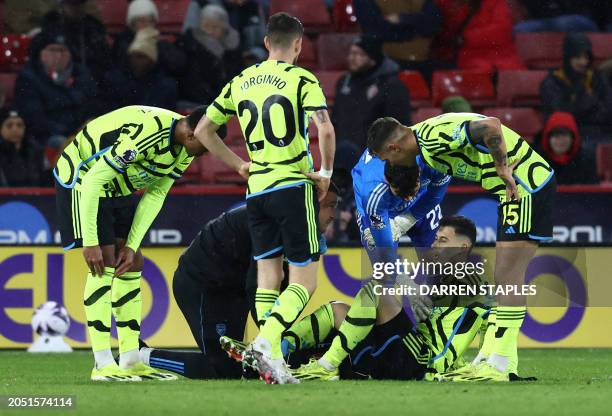 Arsenal's Brazilian midfielder Gabriel Martinelli receives medical treatment during the English Premier League football match between Sheffield...