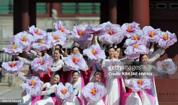 Dancers wearing traditional Korean costumes perform as the city celebrates the recapture of its capital from North Korea in a ceremony marking the...