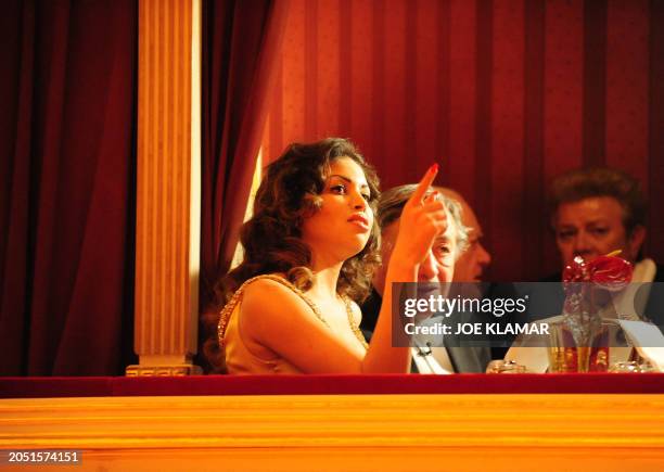 Karima el-Mahroug enjoys the company of her host Austrian businessman Richard Lugner during the traditional Opera Ball at the state opera in Vienna...