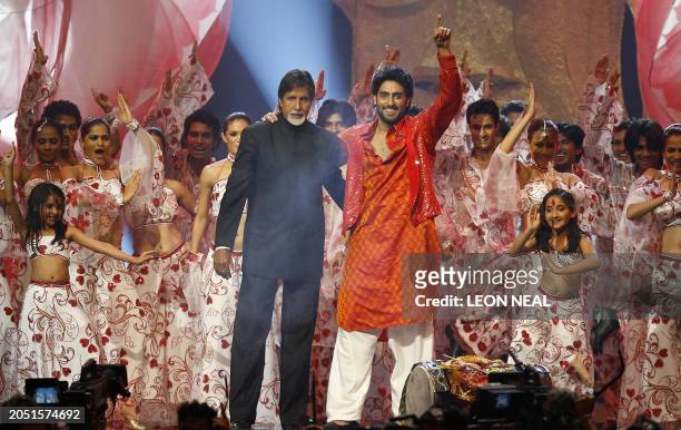 Indian actor Amitabh Bachchan and his son Abhishek Bachchan perform during the International Indian Film Academy Awards ceremony at the Hallam Arena...