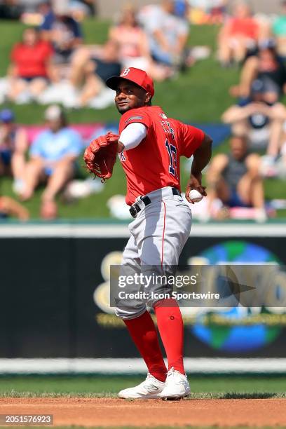 Boston Red Sox infielder Pablo Reyes throws the ball over to first base during the spring training game between the Boston Red Sox and the Detroit...