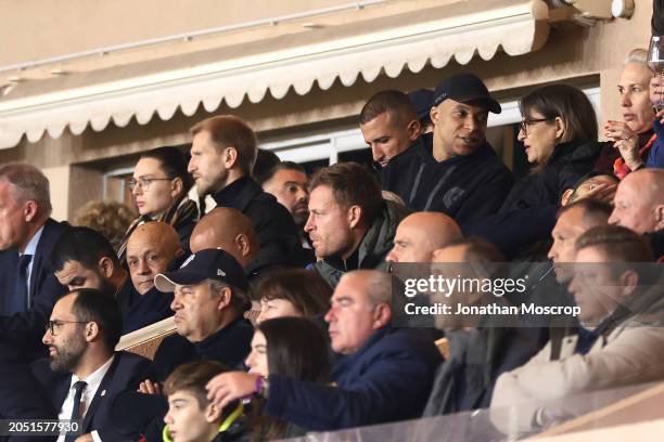 Kylian Mbappe of PSG looks on from the tribune with his mother Fayza Lamari after being substituted at half time of the Ligue 1 Uber Eats match...