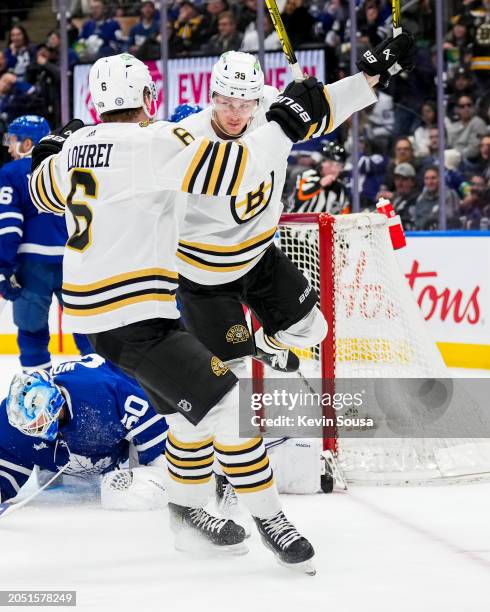 Morgan Geekie of the Boston Bruins celebrates his goal against the Toronto Maple Leafs with teammate Mason Lohrei during the first period at...