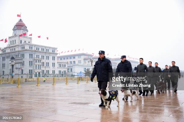 Plain clothes security walk outside the Great Hall of the People during the opening ceremony of the National People's Congress on March 5, 2024 in...