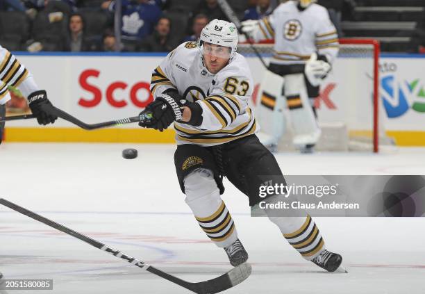 Brad Marchand of the Boston Bruins fires a puck in against the Toronto Maple Leafs during an NHL game at Scotiabank Arena on March 4, 2024 in...