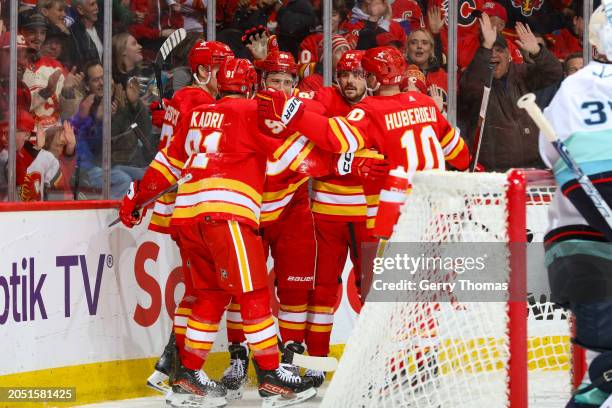 Nazem Kadri of the Calgary Flames joins teammates to celebrate a goal against the Seattle Kraken at Scotiabank Saddledome on March 4, 2024 in...