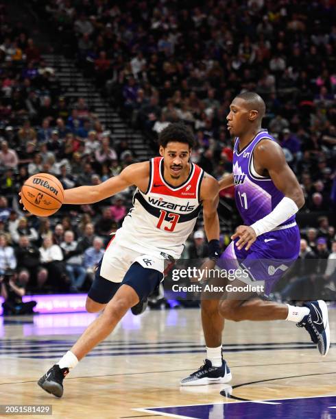 Jordan Poole of the Washington Wizards drives against Kris Dunn of the Utah Jazz during the second half of a game at Delta Center on March 04, 2024...