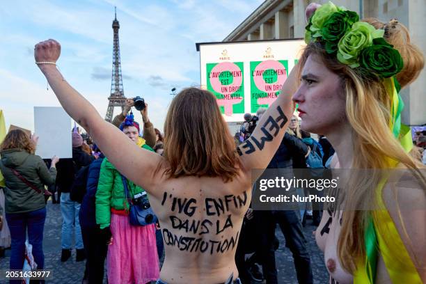 Contains nudity) People gathered near the Eiffel Tower at the Place du Trocadero in Paris on March 4 to celebrate the inclusion of the right to...