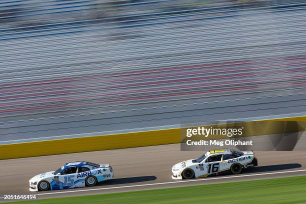 Hailie Deegan, driver of the AirBox Ford, and AJ Allmendinger, driver of the Action Industries Chevrolet, drive during practice for the NASCAR...