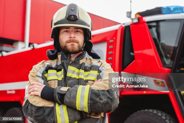 confident firefigher wearing protective gear - firefighter getting dressed stock pictures, royalty-free photos & images