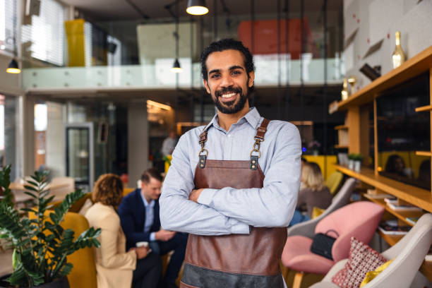 A smiling diner confidently speaking to a waiter in a busy, modern bistro setting