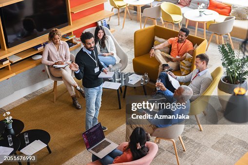 Overhead View Of A Middle Eastern Department Manager Having A Relaxed Business Meeting With His Employees Overhead View Of A Middle Eastern Department Manager Having A Relaxed Business Meeting With His Employees