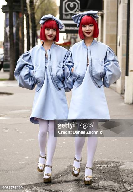 Ami Amiaya and Aya Amiaya are seen wearing matching light blue jackets, light blue dresses, light blue bow's, white leggings and gold platform shoes...