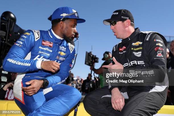 Rajah Caruth, driver of the HendrickCars.com Chevrolet, and Kyle Busch, driver of the Group 1001 Chevrolet, talk on the grid during practice for the...