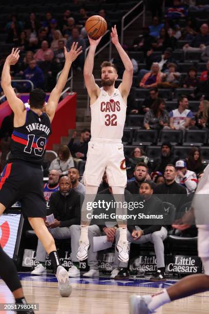 Dean Wade of the Cleveland Cavaliers takes a first half shot next to Simone Fontecchio of the Detroit Pistons at Little Caesars Arena on March 01,...