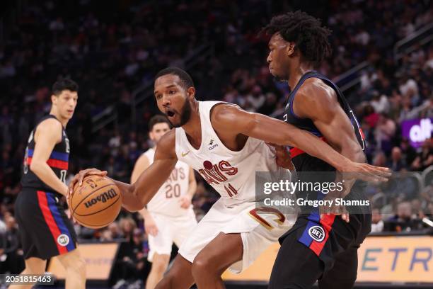 Evan Mobley of the Cleveland Cavaliers tries to drive around James Wiseman of the Detroit Pistons during the first half at Little Caesars Arena on...