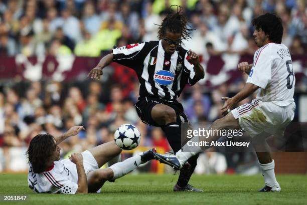 Andrea Pirlo and Gennaro Gattuso of AC Milan attempt to tackle Edgar Davids of Juventus during the UEFA Champions League Final match between Juventus...