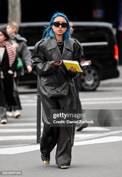 Margaret Zhang is seen wearing a black trench coat and black sunglasses outside the Vetements show during the Womenswear Fall/Winter 2024/2025 as...