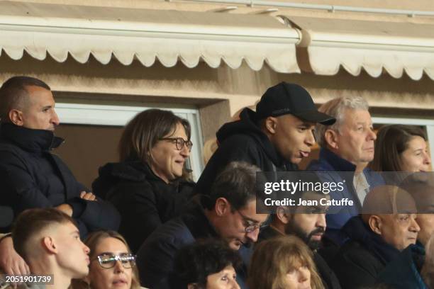 Kylian Mbappe of PSG looks on from the tribune with his mother Fayza Lamari after being substituted at half time during the Ligue 1 Uber Eats match...