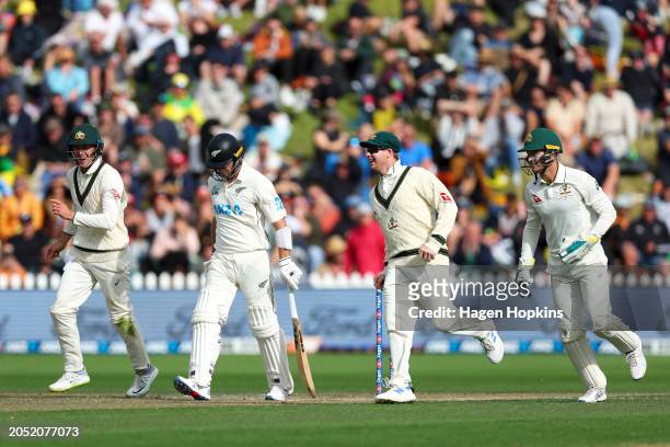 Steve Smith of Australia celebrates after taking the wicket of Will Young of New Zealand during day three of the First Test in the series between New...