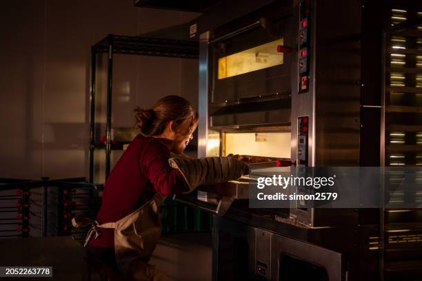 baking brilliance: asian trainee crafts perfect buns in culinary school kitchen - amber light stock pictures, royalty-free photos & images