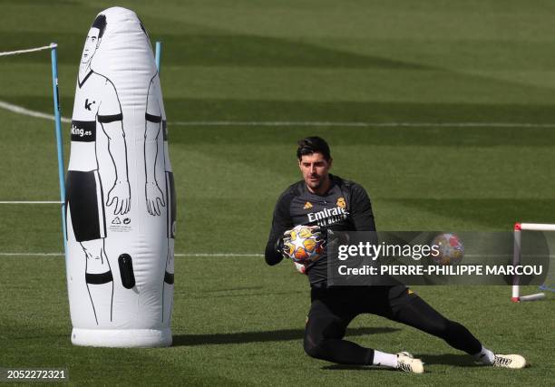 Real Madrid's Belgian goalkeeper Thibaut Courtois trains on the eve of the UEFA Champions League last 16 second leg football match against RB Leipzig...