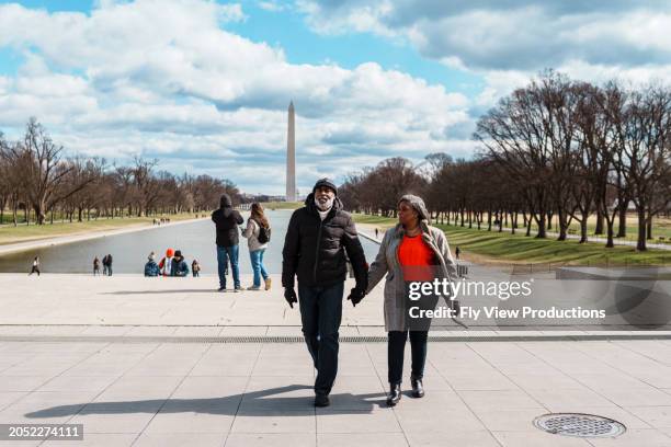 black senior couple exploring the washington mall while visiting washington dc - the mall washington dc stock pictures, royalty-free photos & images