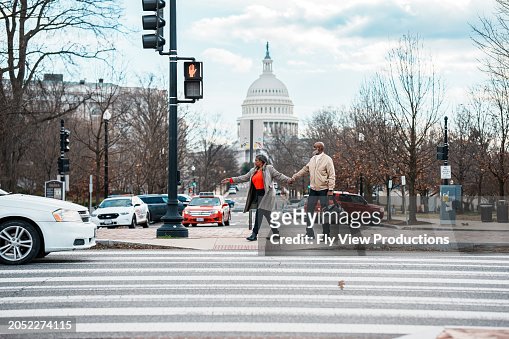 African American couple walking hand in hand along the street in Washington DC