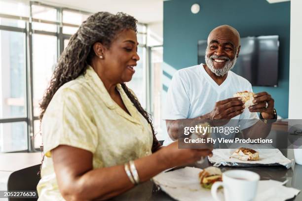 african american senior couple eating breakfast in hotel room while on vacation - luxury pyjamas stock pictures, royalty-free photos & images