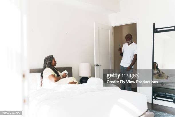 senior couple enjoying a relaxing morning at their luxury hotel - luxury pyjamas stock pictures, royalty-free photos & images