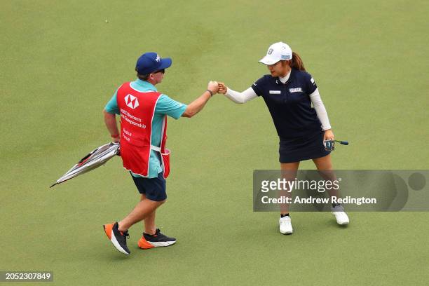 Ayaka Furue of Japan fist bumps her caddie on the 18th green during Day Three of the HSBC Women's World Championship at Sentosa Golf Club on March...