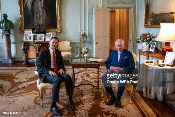 King Charles III meets with Chancellor of the Exchequer Jeremy Hunt in the private audience room at Buckingham Palace on March 5, 2024 in London,...
