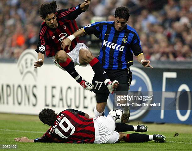 Francesco Coco of Inter Milan is tackled by both Rui Costa and Alessandro Costacurta of AC Milan during the UEFA Champions League Semi-Final First...