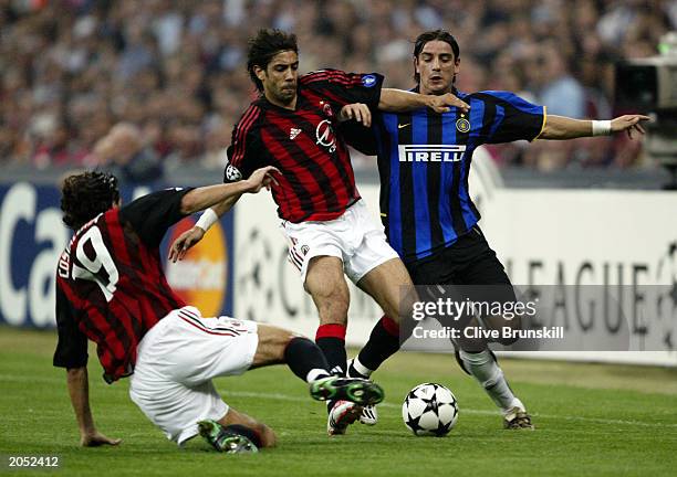 Rui Costa and Alessandro Costacurta of AC Milan both reach the ball ahead of Francesco Coco of Inter Milan during the UEFA Champions League...