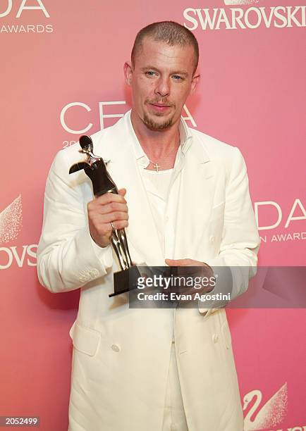 Designer Alexander McQueen, winner of the "International Award" poses backstage at the "2003 CFDA Fashion Awards" at the New York Public Library on...