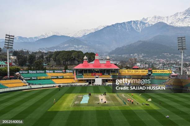 General view of the Himachal Pradesh Cricket Association Stadium shows India's players attending a practice session, ahead of the fifth and final...