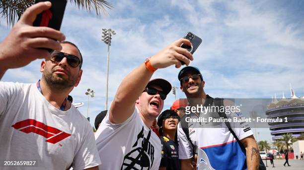 Daniel Ricciardo of Australia and Visa Cash App RB greets fans as he arrives at the circuit prior to the F1 Grand Prix of Bahrain at Bahrain...