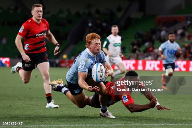 Tane Edmed of the Waratahs beats out Sevu Reece of the Crusaders in a chase down to prevent a try during the round two Super Rugby Pacific match...