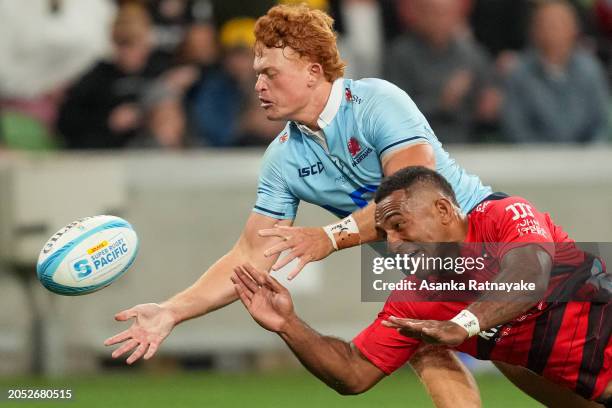 Tane Edmed of the Waratahs and Sevu Reece of the Crusaders contest for the ball near the try line during the round two Super Rugby Pacific match...
