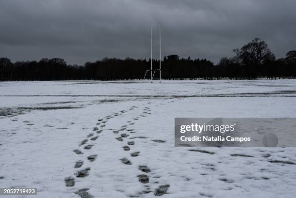 Footprints on the snowy foreground can be seen, and a Gaelic football goal posts in the background, on March 2, 2024 in Dublin, Ireland. Following...